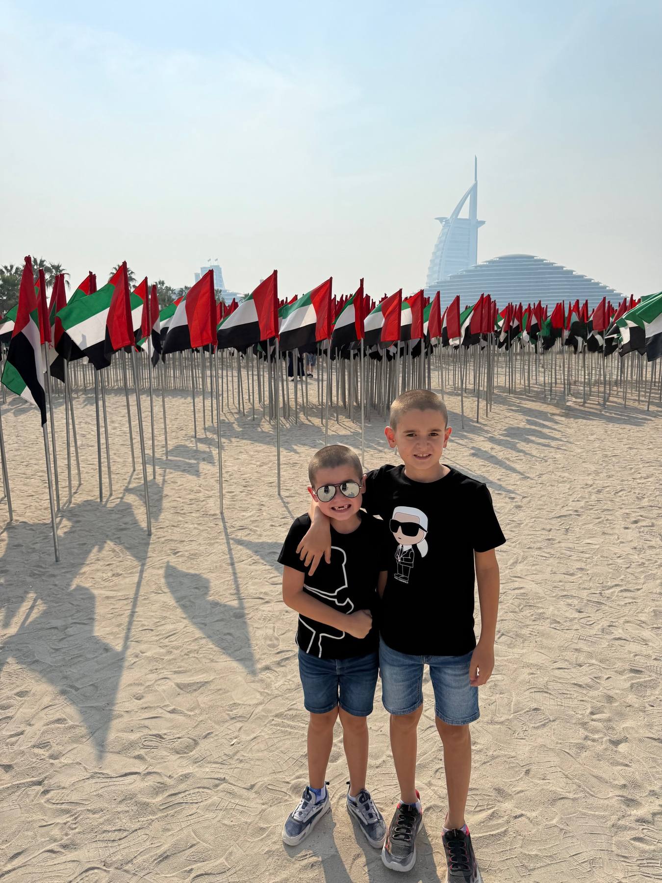 Aaron and Nathan with UAE flags and Burj Al Arab